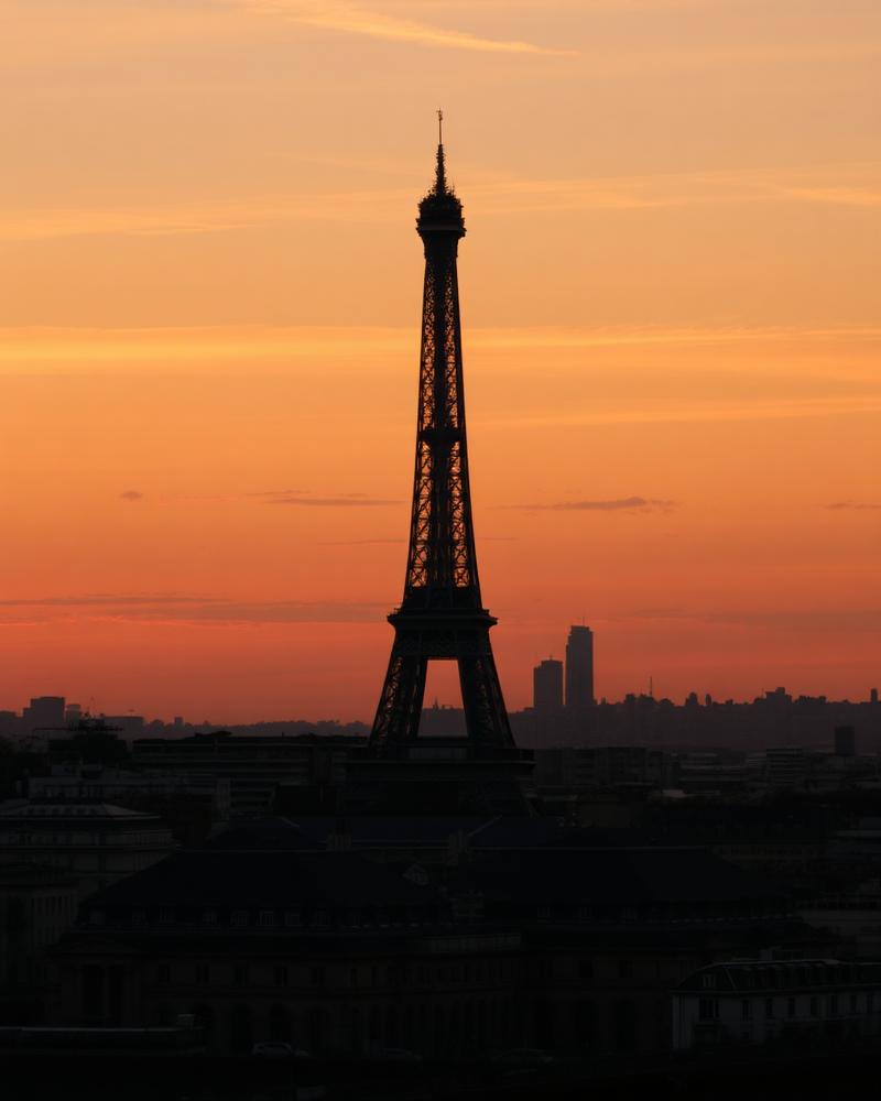 The Eiffel Tower silhouetted against a warm Paris sunset